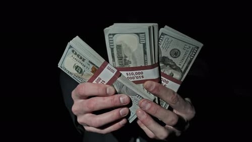 Mysterious Hands Holding Stacks of One Hundred Dollar Bills
