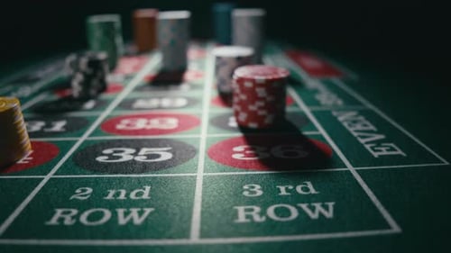 Close Up of Bet Stacks of Chips on a Green Casino Roulette Table