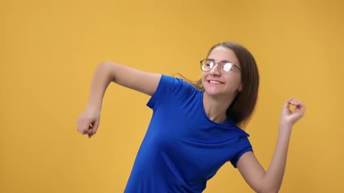 Portrait Laughing Casual Blonde Woman Dancing Enjoying Fun Freedom Posing Isolated on Orange Studio