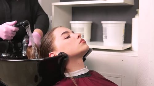 Woman Getting Hair Washed at Hair Salon