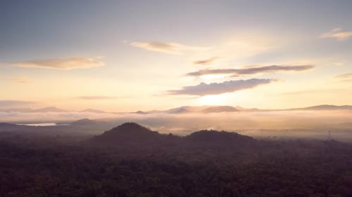 Aerial View of Sunrise Over Forest and Mountains