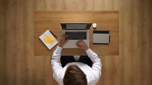 Typing, Writing and Planning at Desk Overhead Shot