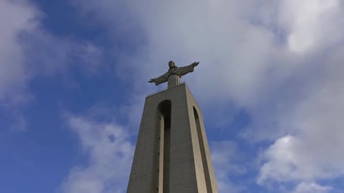 Christ King Statue Against a Blue Sky with Clouds
