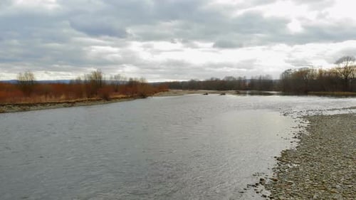 Low Flying Drone Over the River with Rocks