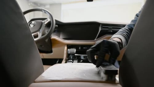 Detailer Cleaning Car Center Console with Brush