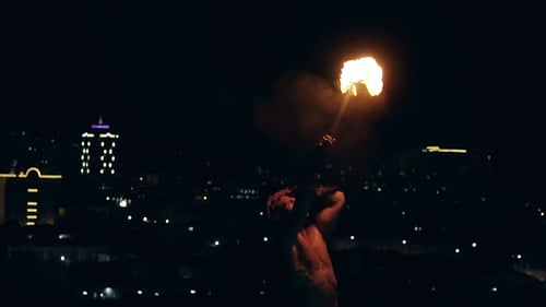 Young Blond Male Breathes Out Large Stream of Fire Making Fireball