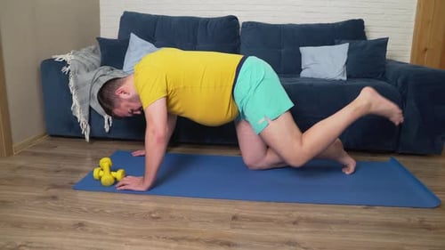 Man Exercising on Yoga Mat in Living Room