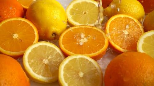 Fresh Citrus Fruits Being Sprinkled with Water