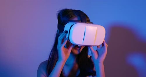Woman Wearing VR Headset in Blue and Purple Light