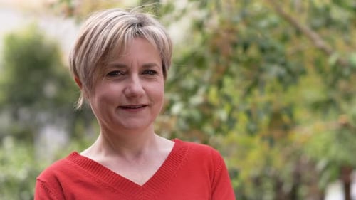Woman Smiles Outdoors in Natural Setting