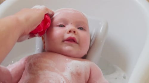 Cute Baby Getting a Bath at Home