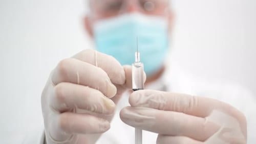 Medical Professional Preparing Syringe Injection, Close Up
