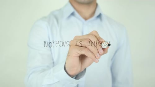 Man Writes Nothing Is Impossible on Clear Surface