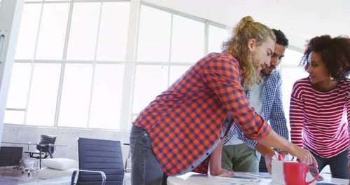 Collaborative Team Working Together Around Table in Office