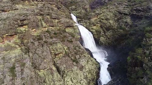 Majestic Waterfall Cascading Down Rocky Mountainside