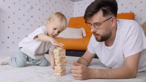 Father and Toddler Playing Blocks on Floor