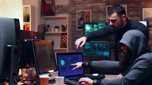 Men Collaborating on Computers Late at Night