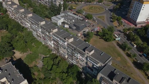 Aerial View of the City with Tall Buildings and a Roundabout Intersection