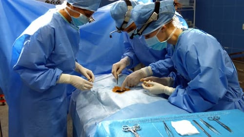 Surgeons performing operation in operation room