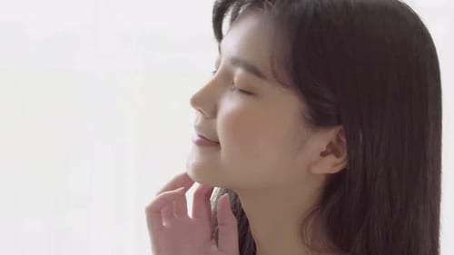 Woman Massaging Face in Skincare Close Up