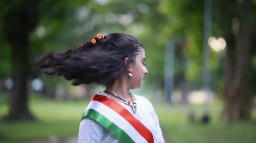 Child with Curly Hair in Park Turns Head
