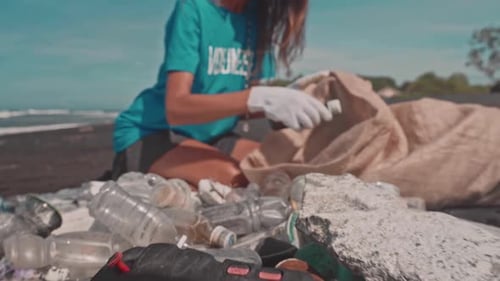 Woman Volunteer Collecting Trash on Beach