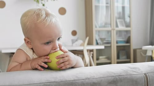 Sweet Toddler Eating Green Apple