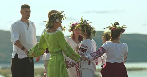 People in Flower Crowns Dance in Rural Midsummer Ritual