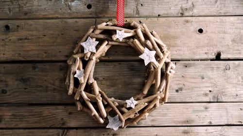 Festive Driftwood Wreath with Stars on Wood Wall