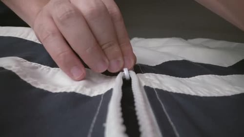 Extreme Close Up Zipper with Hand Unzipping the Sweater Jacket Zipper