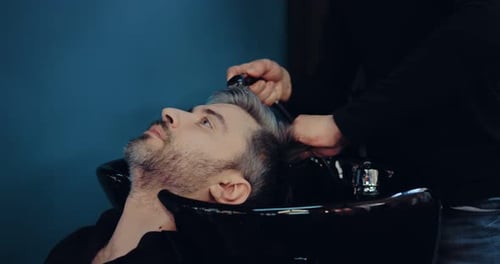 Man Getting Hair Washed at Upscale Barber Shop