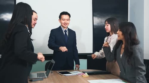 Business Team Celebrates Success with Fist Bump