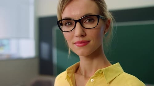 Teacher Posing at Camera in Classroom