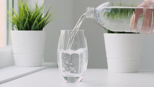 Pouring Fresh Water into Glass