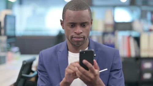 Handsome Man Using Smartphone in Office Setting