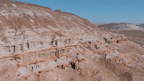 Beautiful red rock formations in desert canyon cliffs, AERIAL PAN