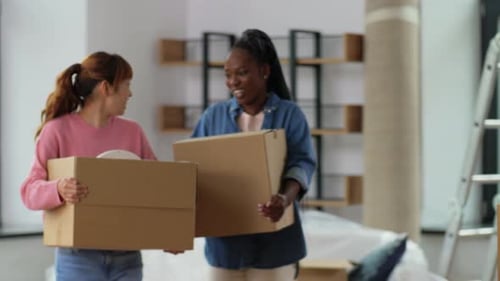 Smiling Young Adults Moving into New Home