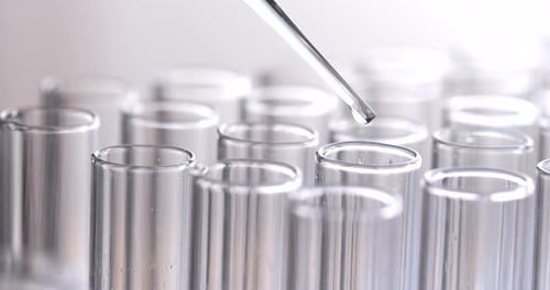 Clear Fluid Dripped Into Test Tubes With Pipette