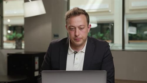 Male office worker communicates in zoom with work colleagues or clients