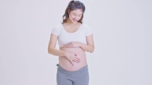 Pregnant Woman Holding and Caressing Her Belly