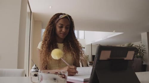 Young Adult Studying at Home With Tablet