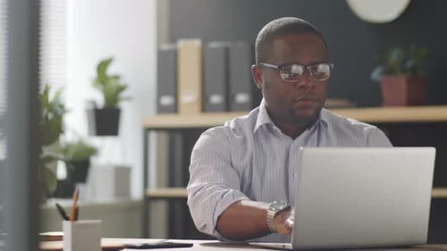 Afro-American Businessman Working on Laptop in Office