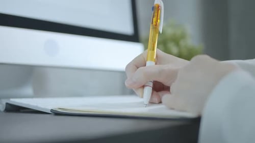 Woman Writing In Office