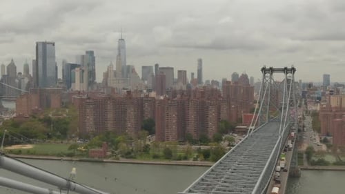 AERIAL: Flight Over Williamsburg Bridge Manhattan Side with New York City Skyline at Cloudy Day