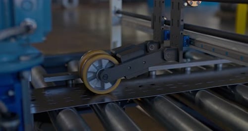 Metal Plate Rides Along a Conveyor Belt Processing Metal Products