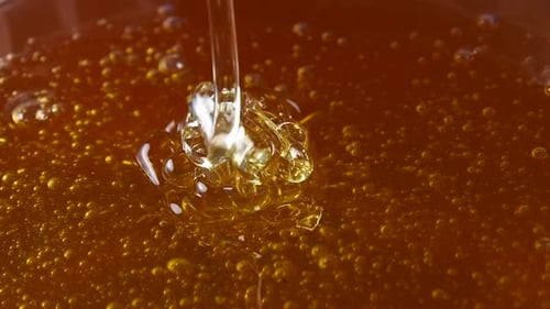 Pouring honey in bowl