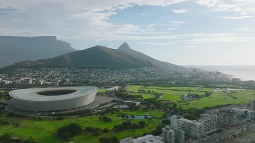 Slider of Sport Venue in Town with Mountain Ridge in Background