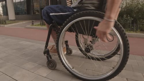 Person Moving in Wheelchair in Urban Setting