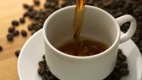 Fresh Coffee Being Poured into a White Cup