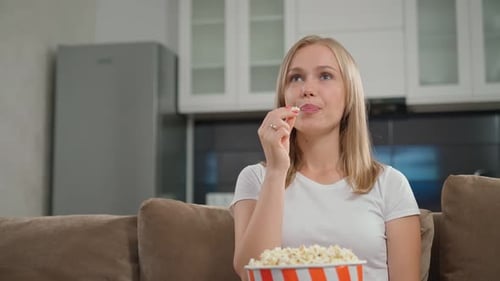 Blonde Woman Enjoys Watching Movie at Home